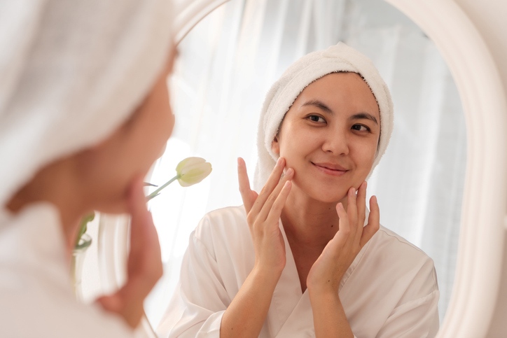 Woman applying vitamin C skincare after cleansing in Fort Collins & Loveland, CO